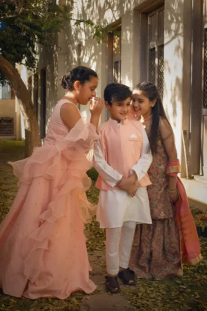Pink net choli with stone work paired with raw silk lehenga & organza frilled dupatta - Rtd